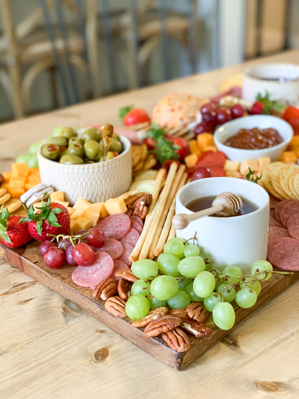 charcuterie board with fruit, meats and cheeses